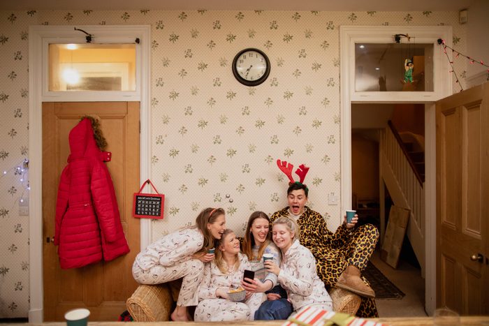 family wearing christmas pajamas at home