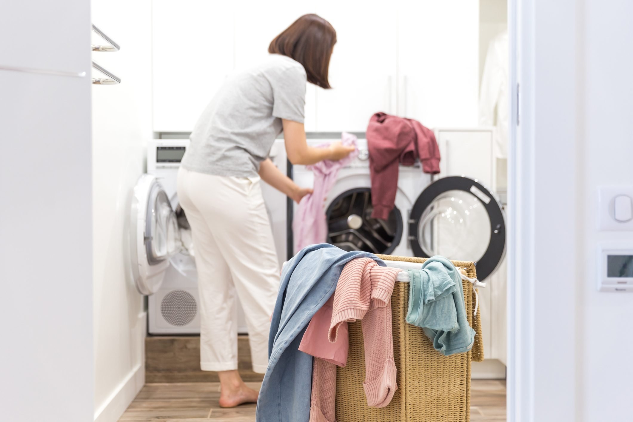 women separating clothes in the dryer clinging together with static electricity
