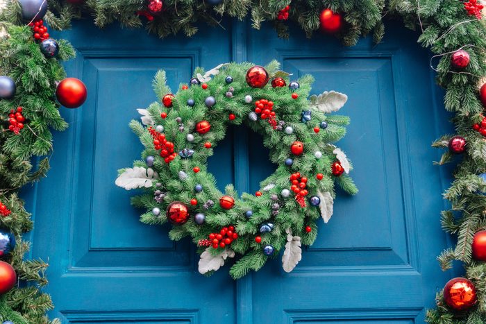 Jingle bells Christmas wreath on a blue door