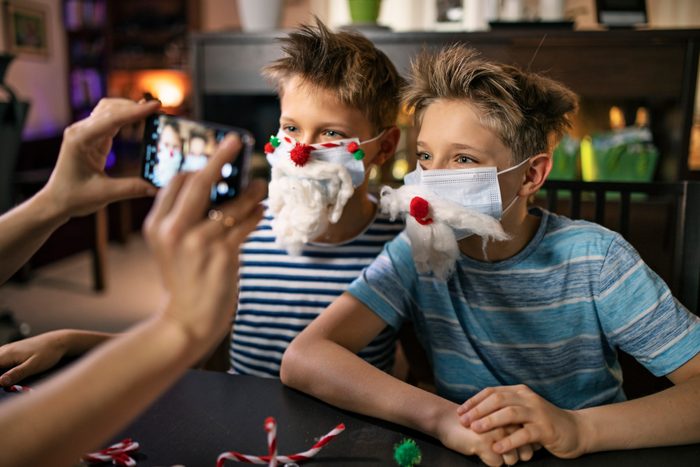 Family decorating surgical face masks for Christmas