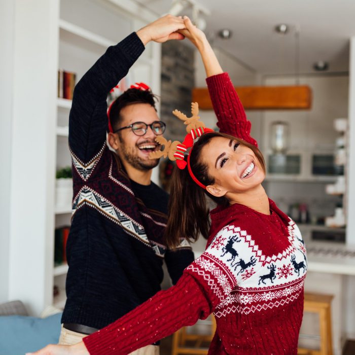 Happy Caucasian couple celebrating winter holidays at home