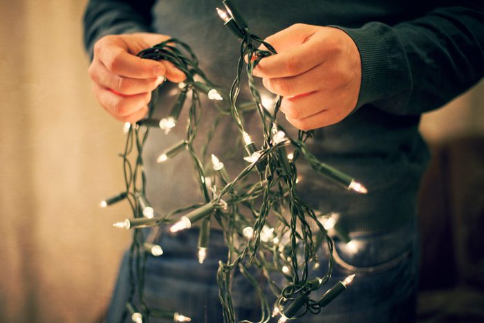 Man holding christmas lights