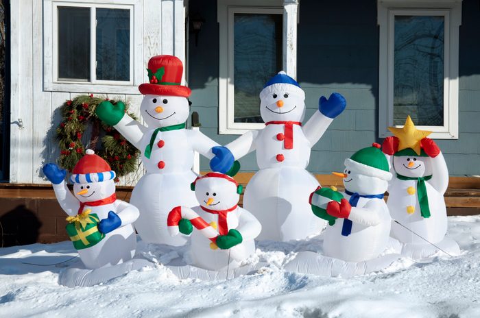 snowman inflatables outside of house during winter