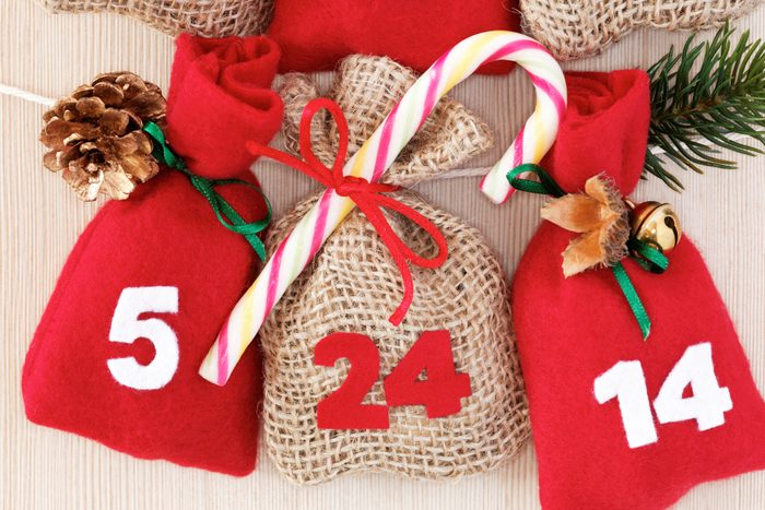 homemade advent calendar with small bags and candy cane