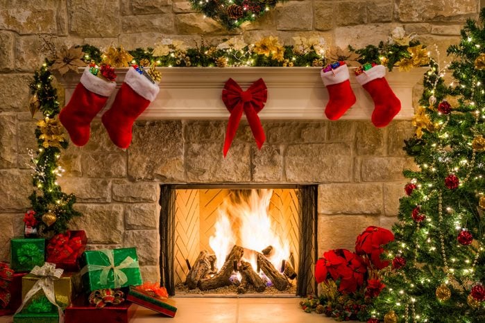 Christmas fireplace, tree, stockings, fire, hearth, lights, and decorations