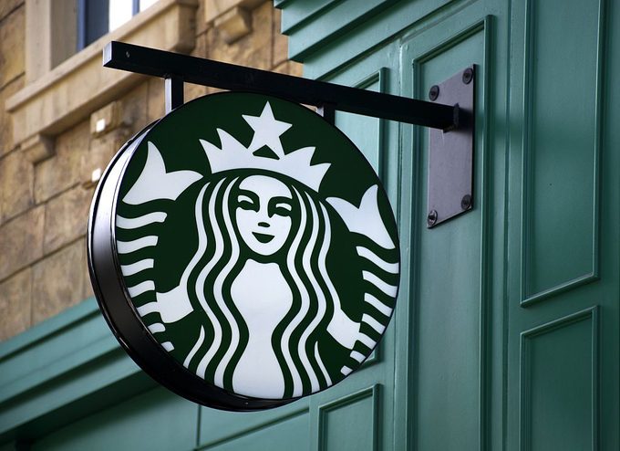 a starbucks logo sign attached to a building
