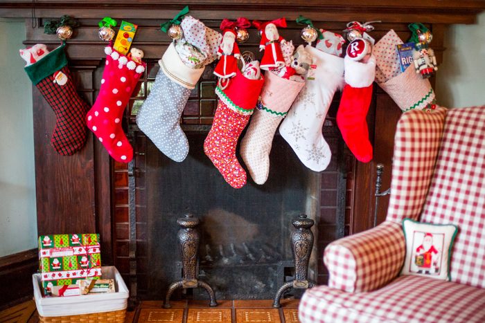 Stuffed Christmas stockings over fireplace