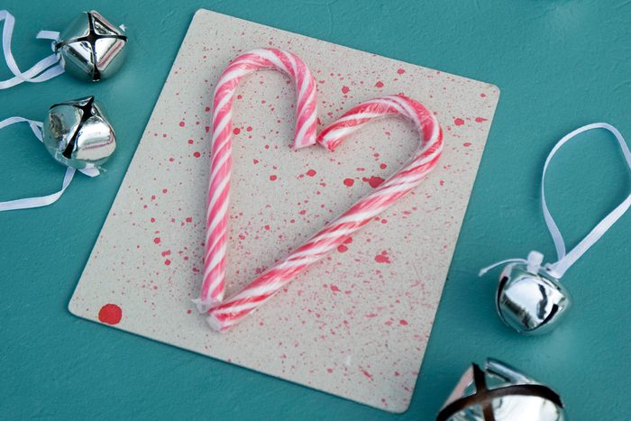 heart made out of candy canes on a blue background