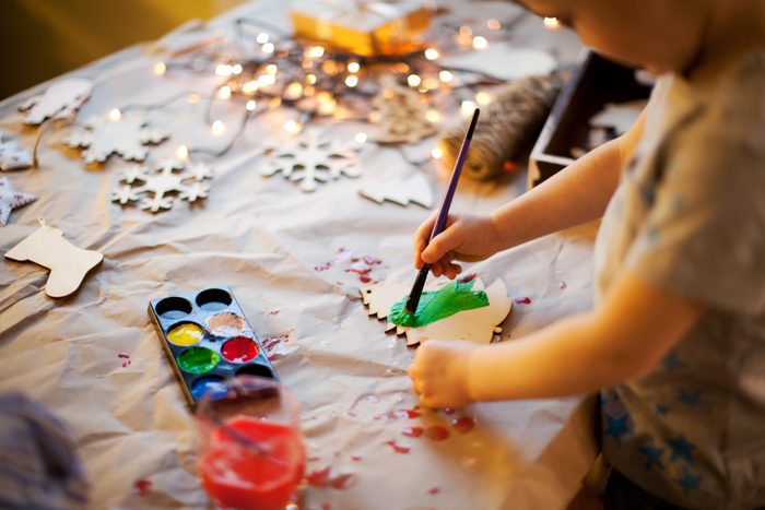 young child making christmas crafts