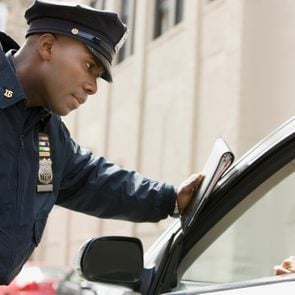 African policeman giving woman ticket