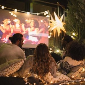 friends watching a movie on an Outdoor Projector
