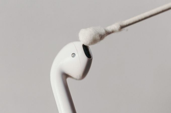 cotton swab cleaning AirPod super close up