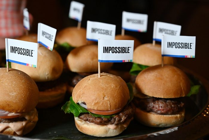 tray of impossible burger sliders each with toothpick flags that say, "impossible"