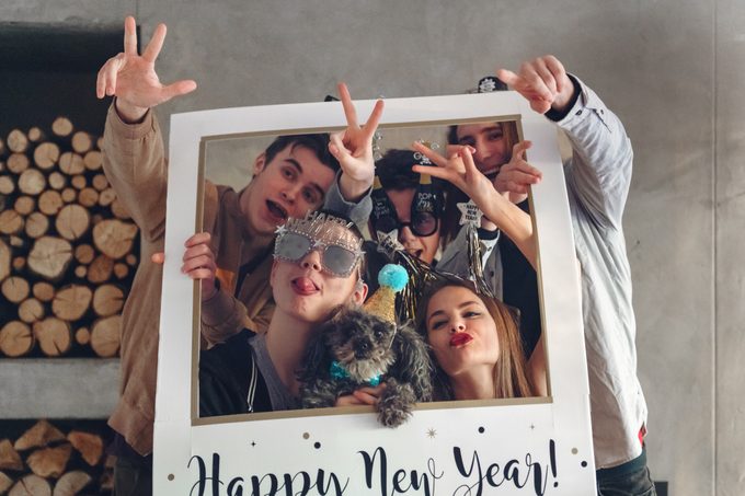 Group Of Teenagers taking photos at a new year's eve party