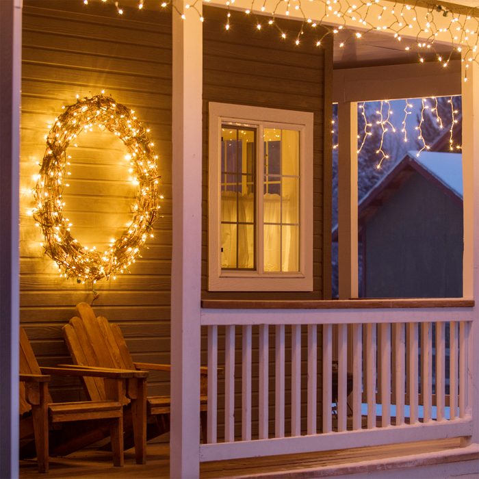 Fairy lights and Christmas wreath on house