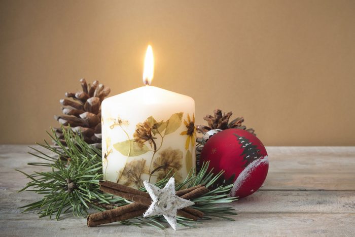 Close-Up Of Christmas candle with decorations on table