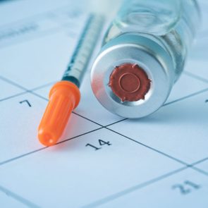 Syringe And Vaccine On A Calendar
