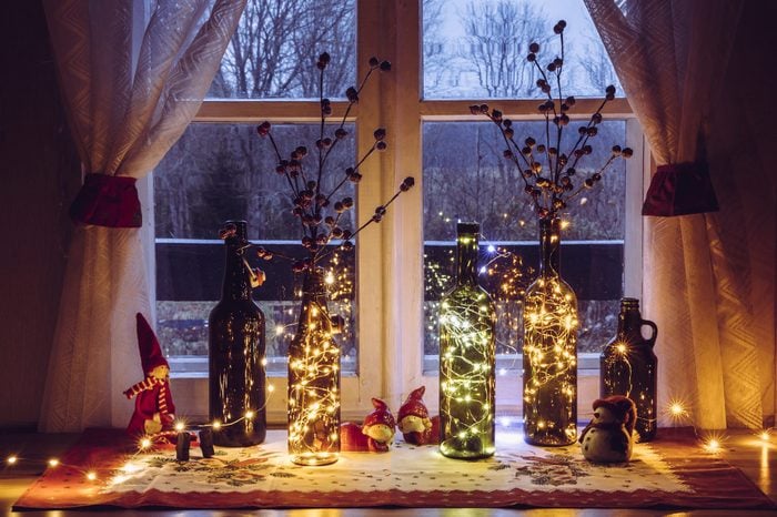 wine bottles with fairy lights decorated for christmas