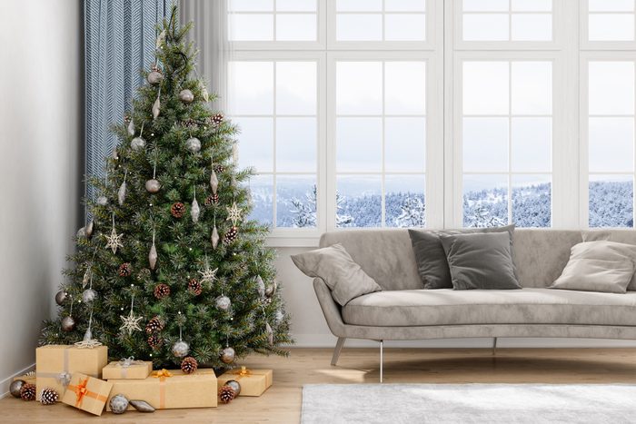 Christmas Tree, Gifts And Sofa With a View Of Snow