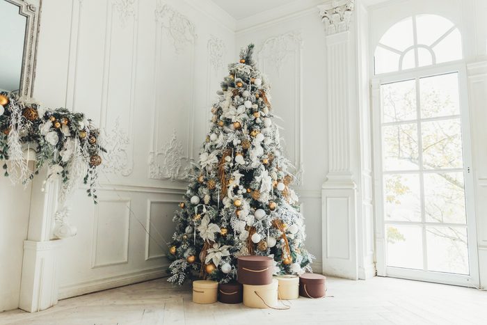 Classic christmas New Year decorated interior room New year tree. Christmas tree with gold decorations