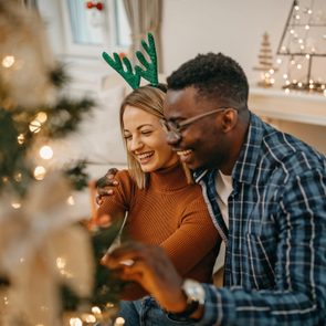 Couple decorating for christmas smiling