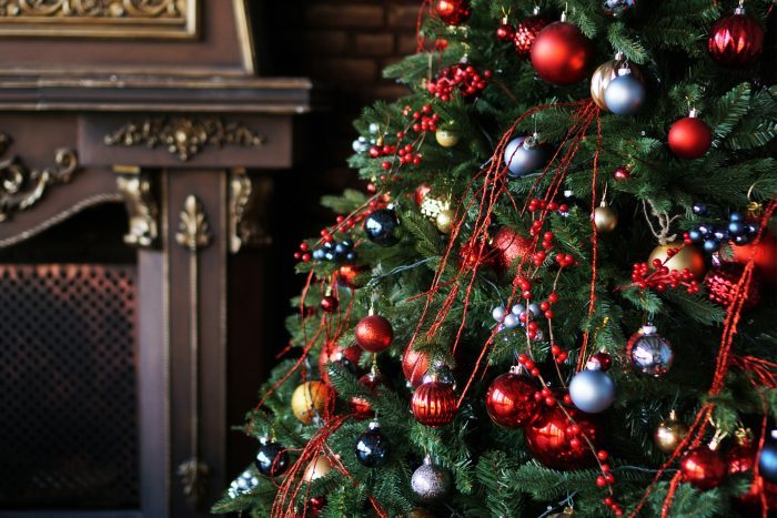 Christmas decorations, Christmas tree with colored balls and brown fireplace