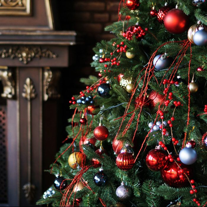 Christmas decorations, Christmas tree with colored balls and brown fireplace