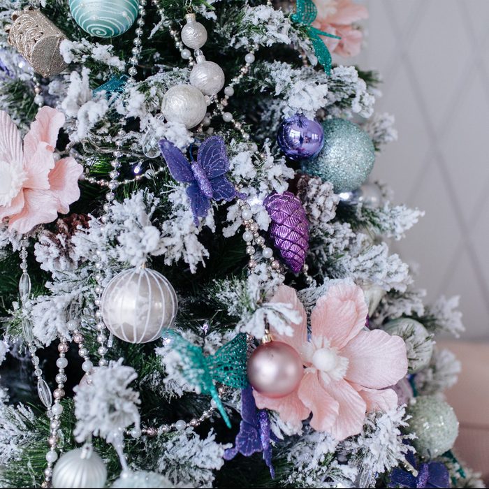 Christmas purple and silver decorations on the Christmas tree, snowflakes balls garlands, closeup texture background