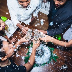 High angle view of friends toasting champagne at party