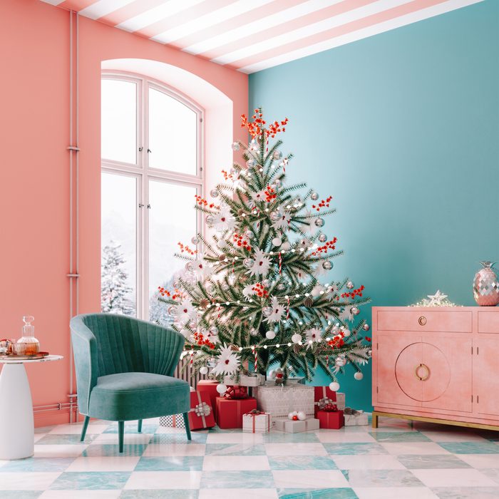 Christmas tree and christmas presents in a modern mid century style room.