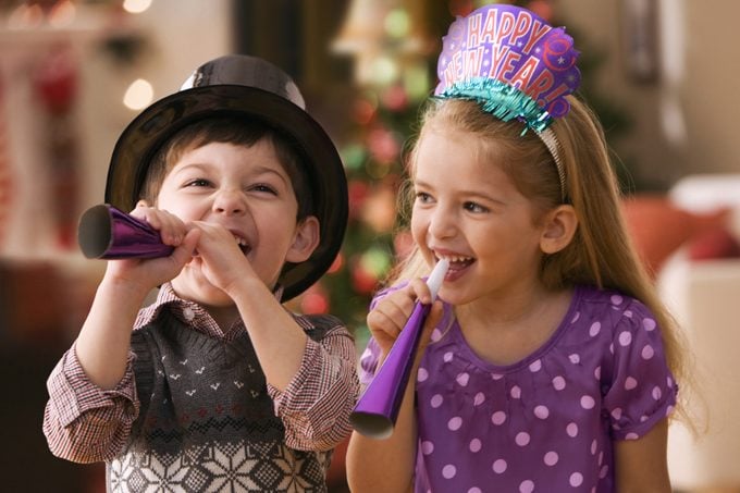 two young children celebrating on new year's eve