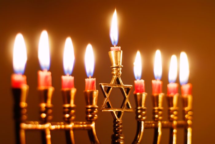Closeup of Hanukkah Menorah lit for the eighth night of hanukkah with candles burning low