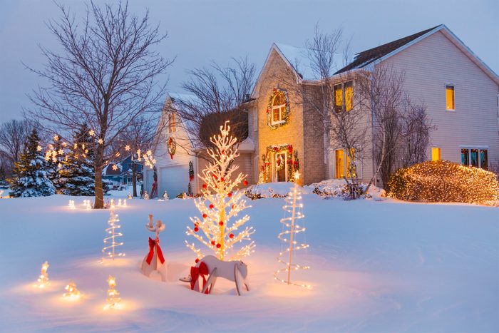 Festive family home with Christmas, holiday decorations, covered in snow