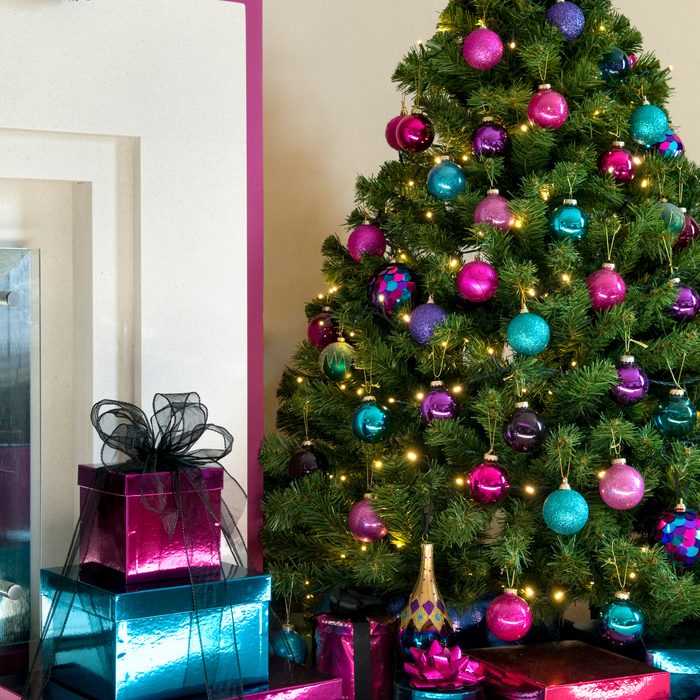 Christmas tree decorated in modern pink, purple and turquoise colours.
