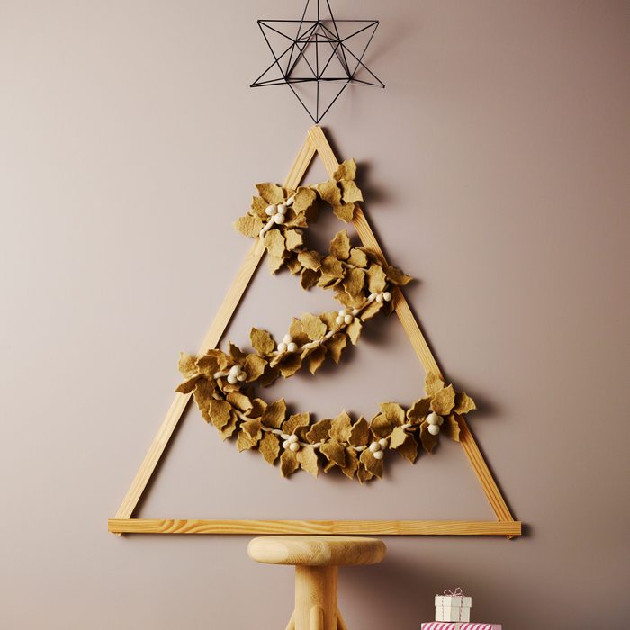 Home decor DIY christmas tree with gift boxes and soft pillows and sheep skin rugs.