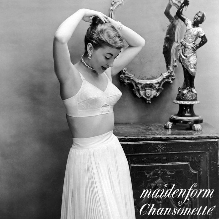 woman adjusting her hair as she poses in an ad for the Maidenform Chansonette bra