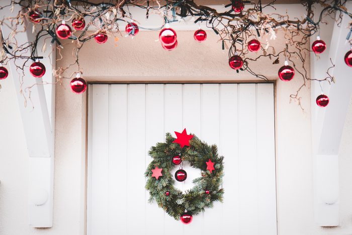 Christmas entrance door decoration white and red with christmas wreath