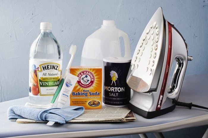 Iron with Cleaning Supplies on ironing board