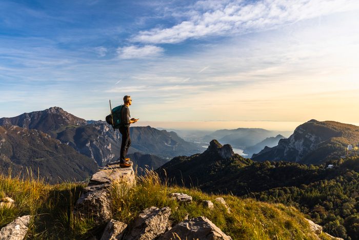 Hiker Alone Looking at View From Mountain Top