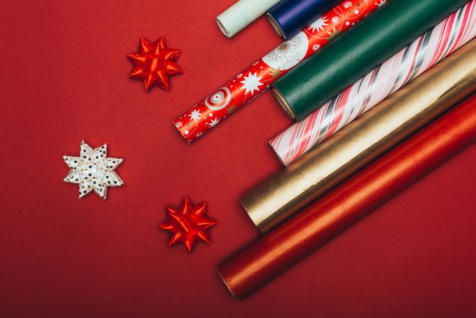top view of wrapping paper rolls and bows on red
