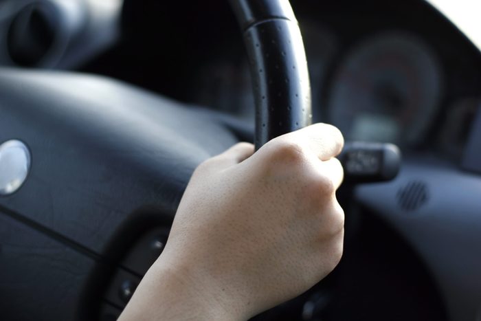 driver gripping steering wheel shaking