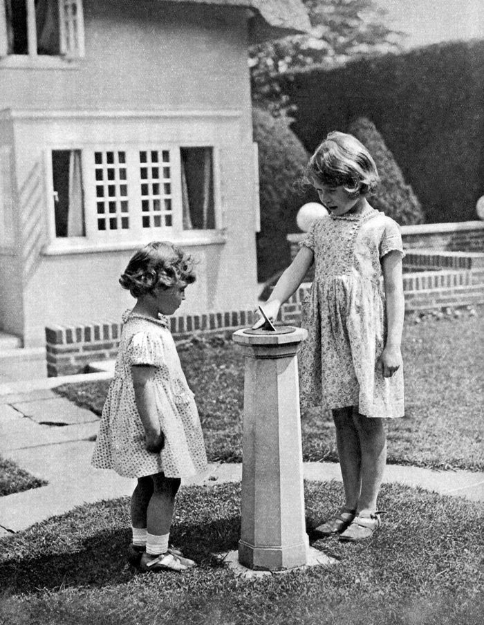 Princess Elizabeth and Princess Margaret as children in the 'grounds' of the model house