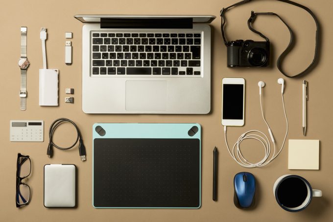 overhead of various electronic products on tan background