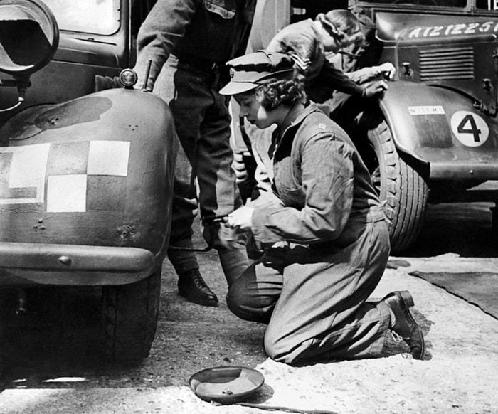 Princess Elizabeth changing the wheel of a military vehicle during the World War II, in an unknown location.