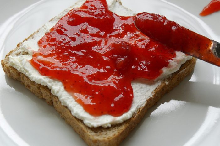 Close-Up Of red jelly on a piece of toast