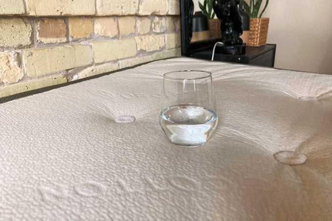 Glass Of Water On top of Avocado Green Mattress