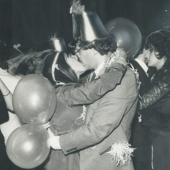 two people kissing at midnight on new year's eve in 1983