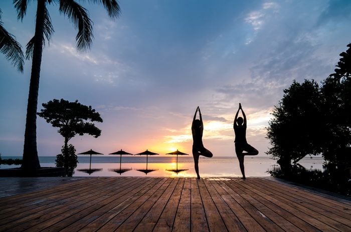 Practise Yoga Beside The Swimming Pool In The Early Morning Silhouette