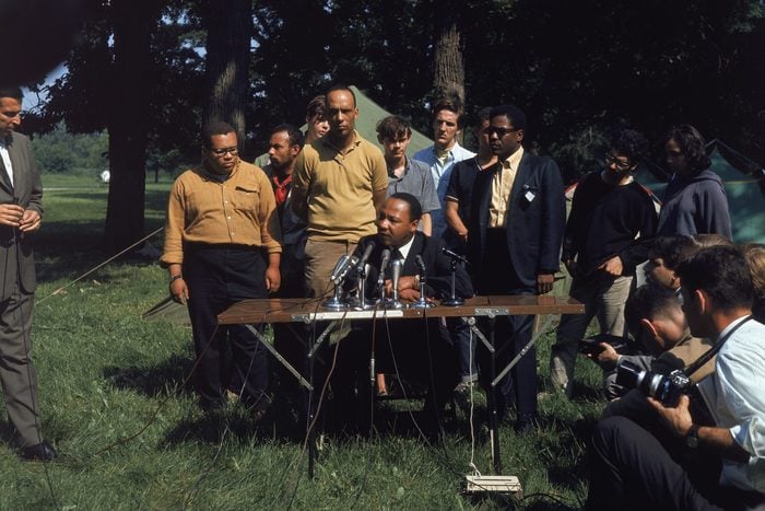 American civil rights activists (L - R) Al Raby, Mike Lawson, Bernard Lee, and Dr. Martin Luther King, Jr. (seated, 1929 - 1968) hold an outdoor press conference at the Cenacle "tent-in" at Warrenville, Illinois, June 23, 1967.