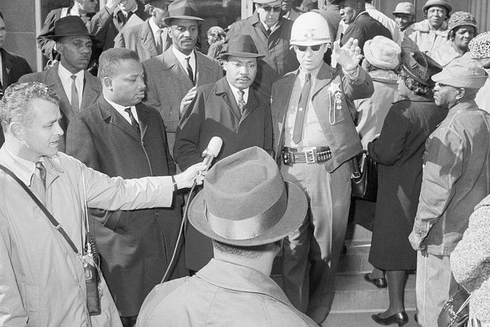 Martin Luther King With Deputy Sheriff trying to be interviewed